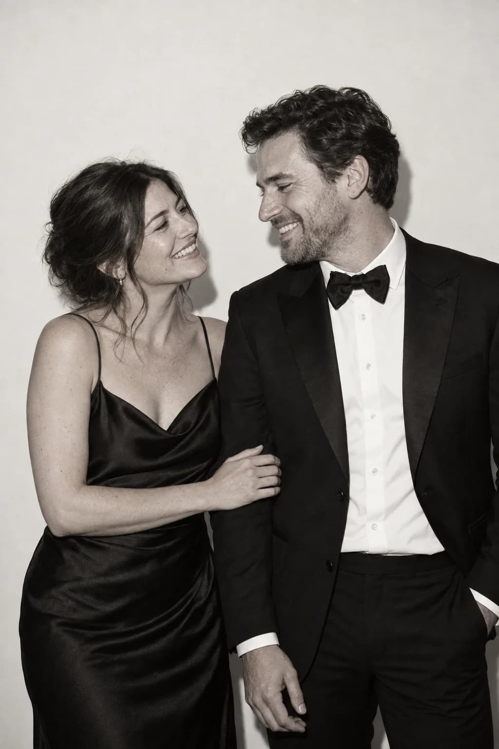 Two guests sharing a quiet smile in front of the camera