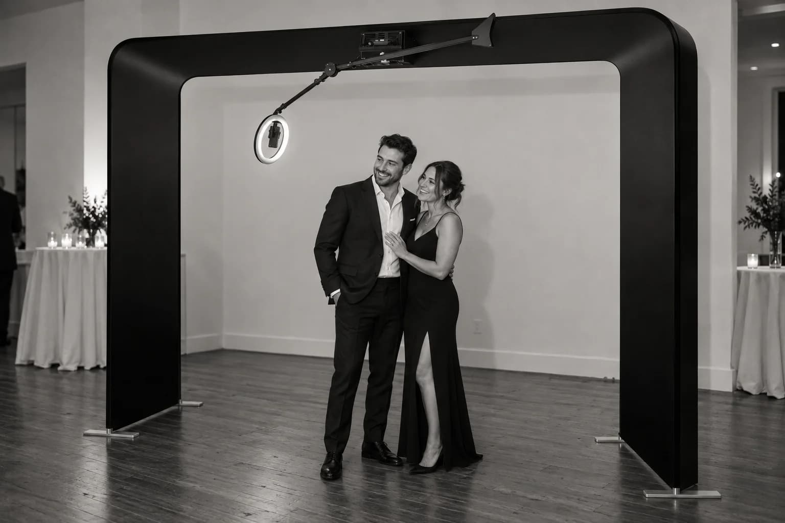 Black overhead 360 arch with rotating arm and ring light; guests stand on the floor